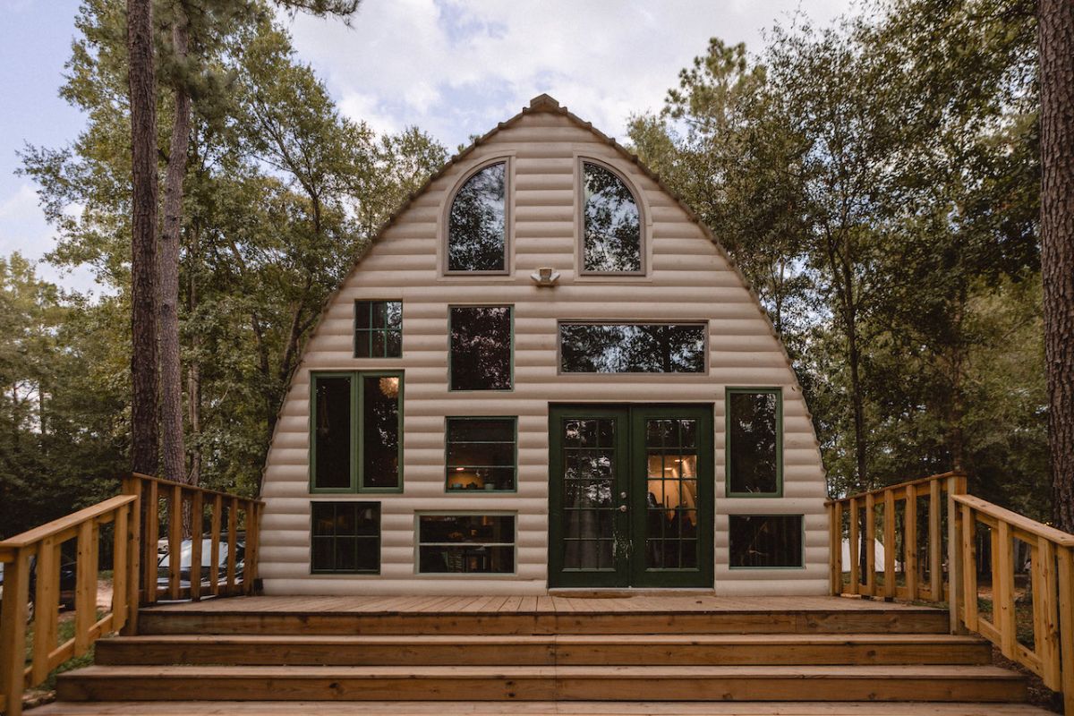 front of arched roof cabin with unique display of windows