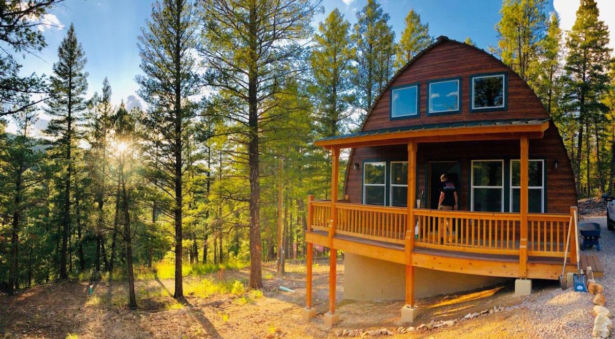 cabin on hill with trees in background