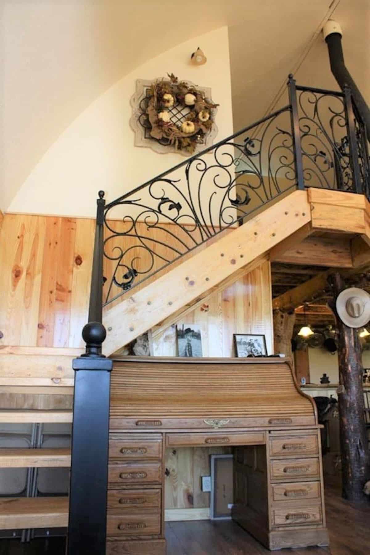 stairs to loft with wrought iron intricate railing