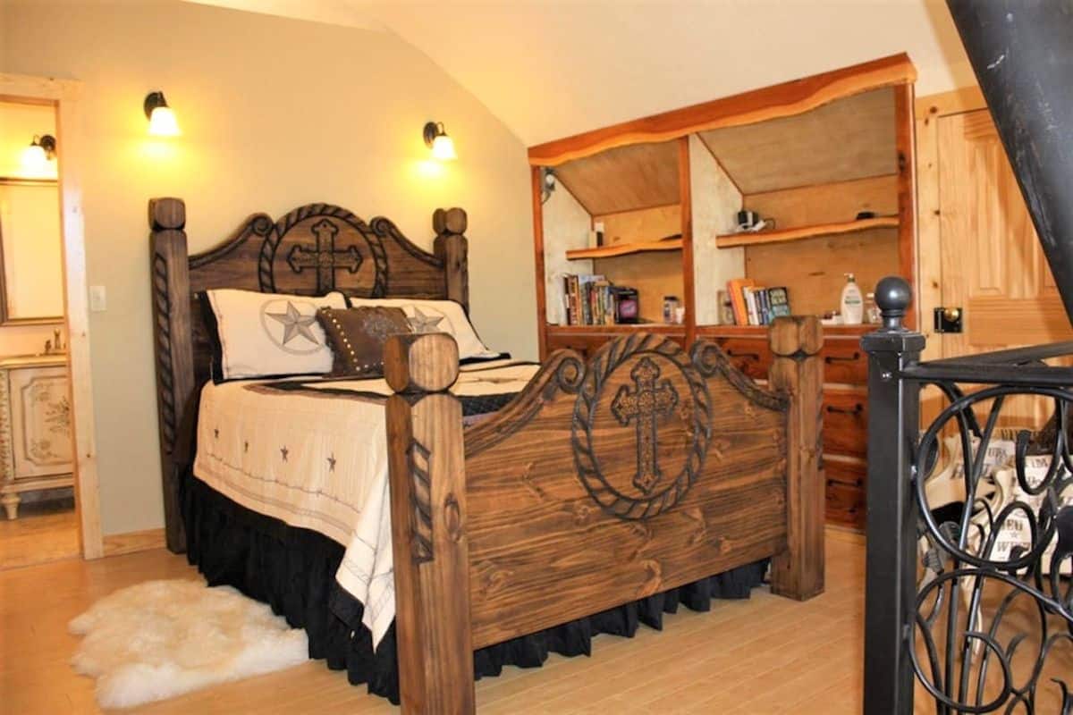 wood bed frame with metal cross on footboard