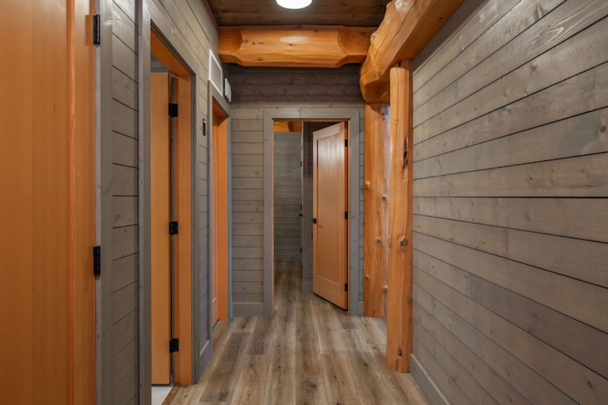 greay wood walls in hall with accent beams around doors