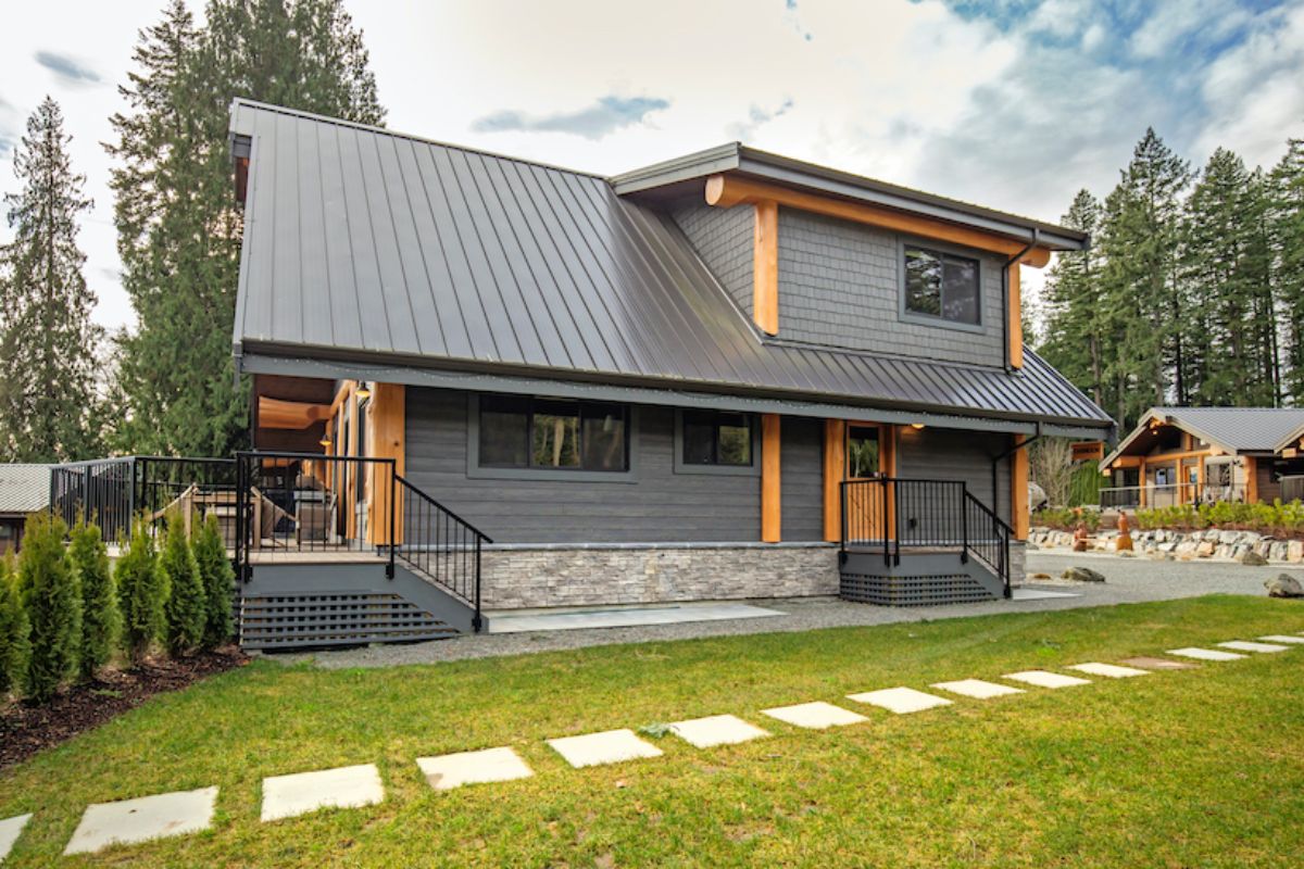 wrought iron rails on porches on side of gray and wood cabin