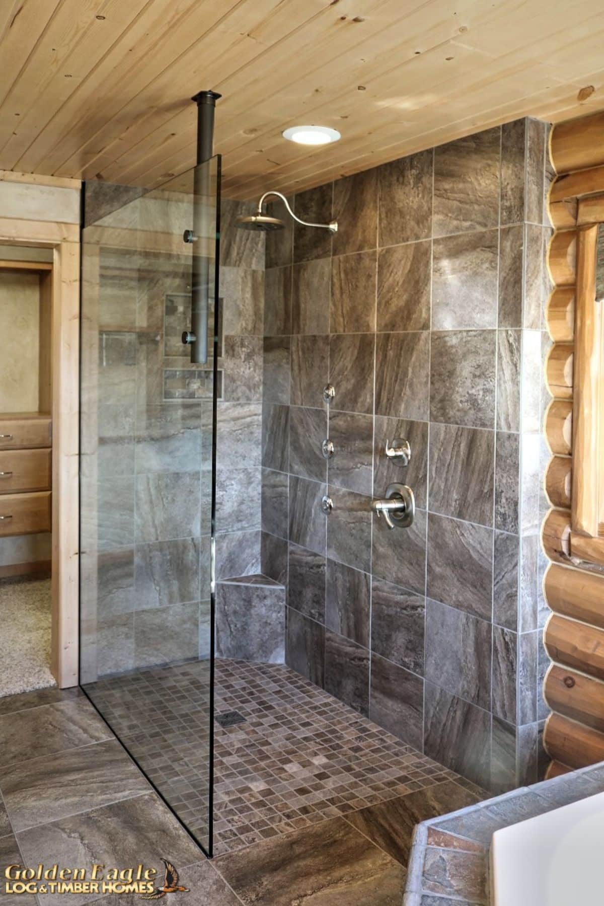 gray tile shower with glass doors