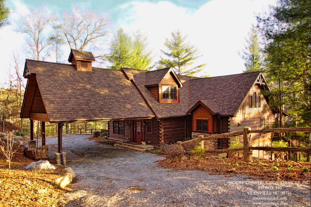 awning over front door driveway area on front of log cabin with gravel drive