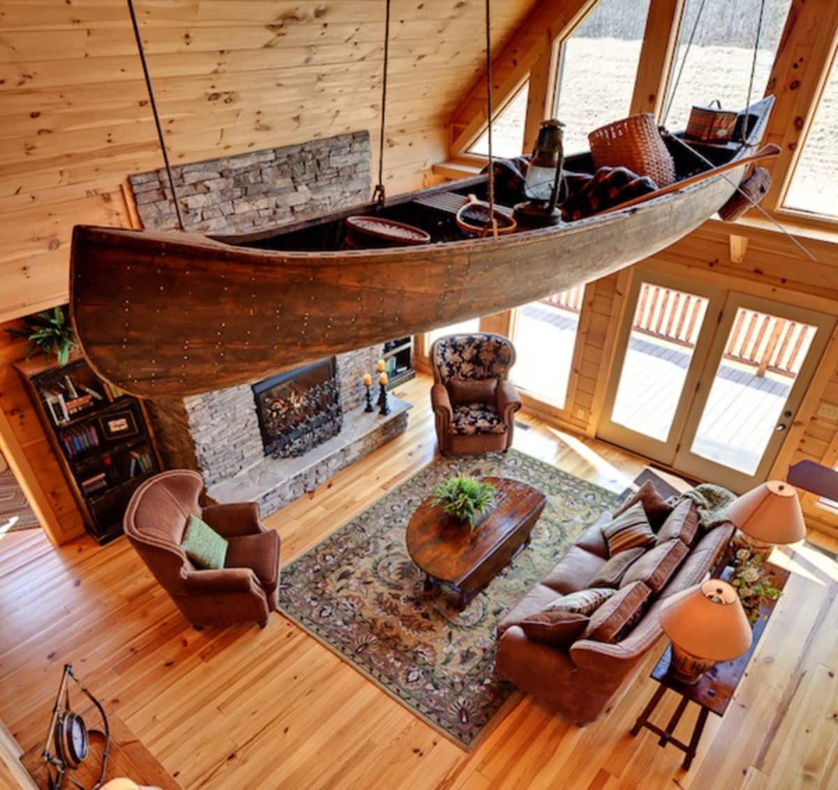 wood canoe hanging from ceiling above living room