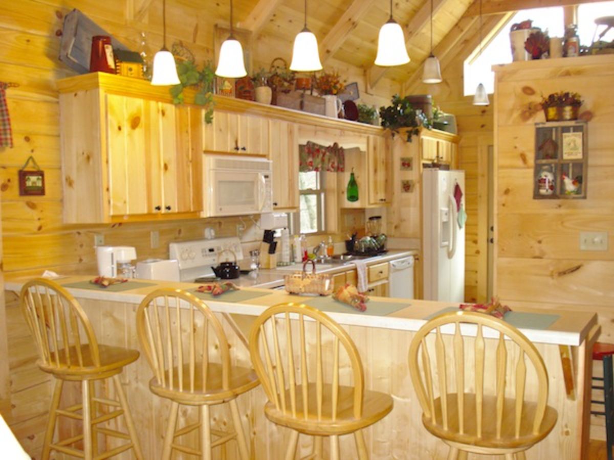 high back wood stools at bar in kitchen with light wood cabinets