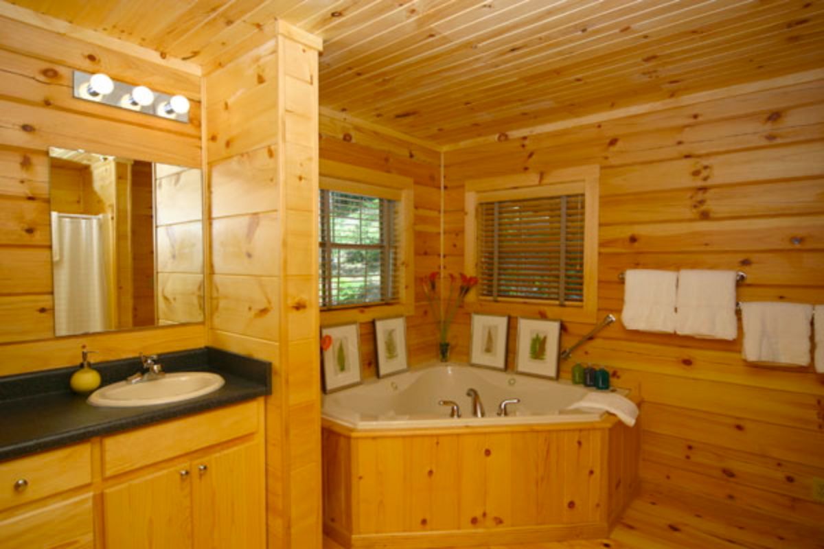wood walls in bathroom with small soaking tub in corner