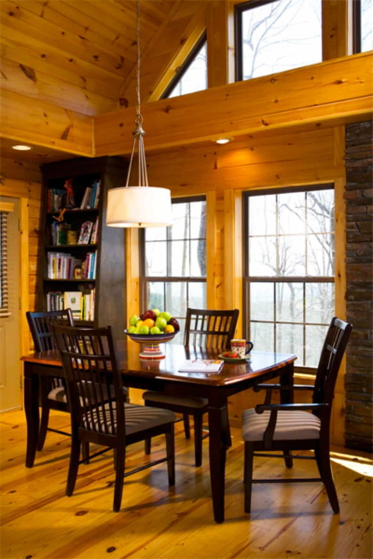 black table with light colored upholstery on chair bases in dining space