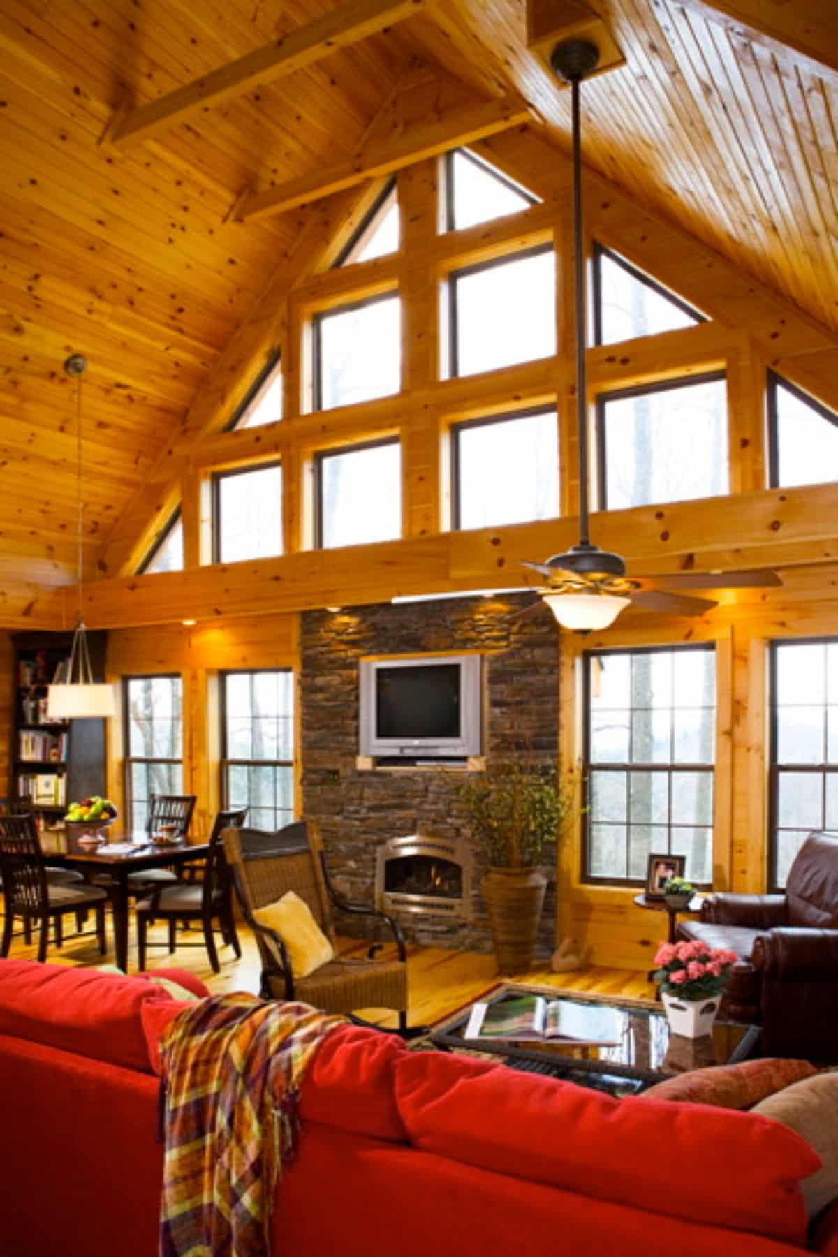 wall of windows with stone fireplace in center