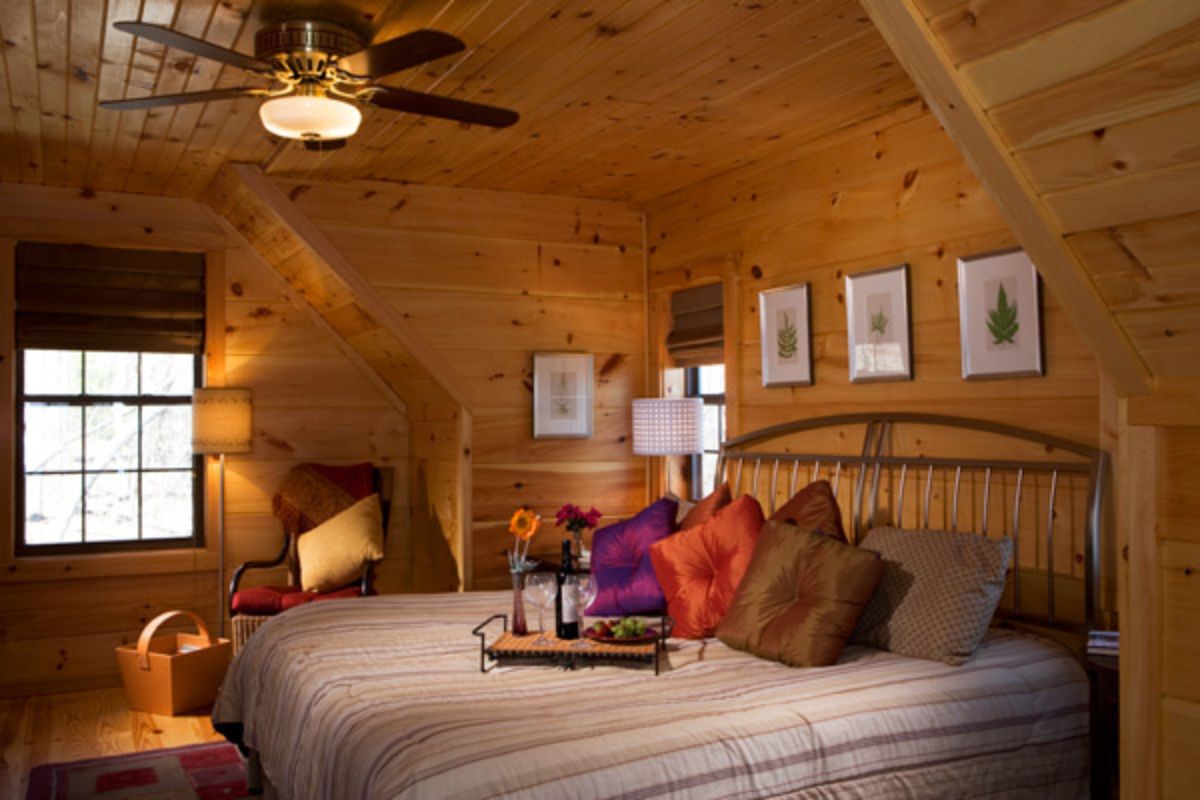 breakfast tray on edge of bed in cabin bedroom