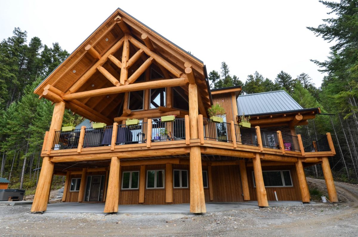 back of log cabin with covered upper deck