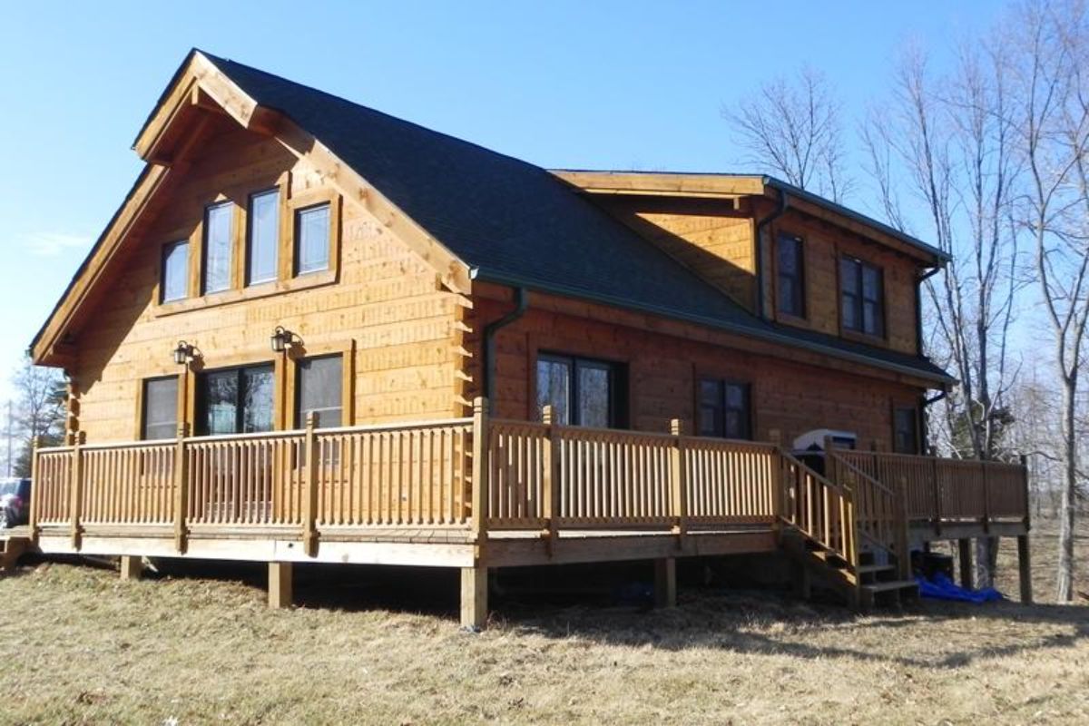 back side of cabin showing porch with stairs leading to side of property