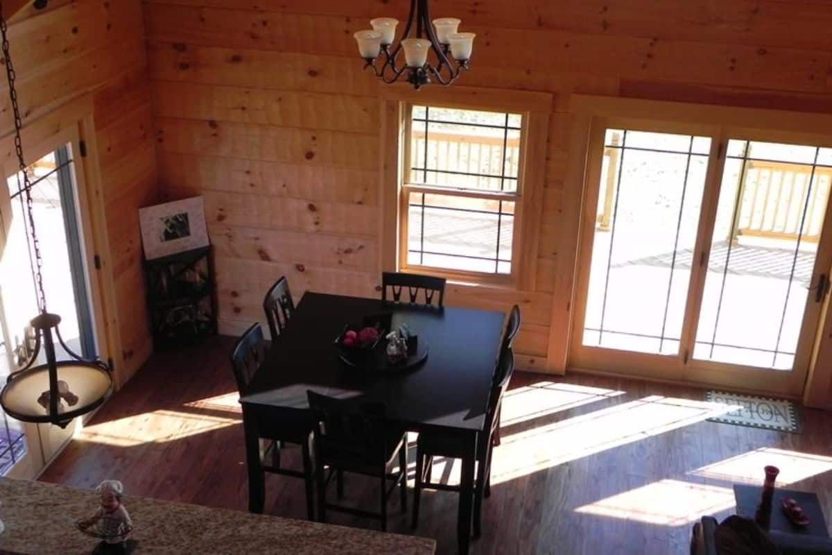 square dining table next to glass door to porch