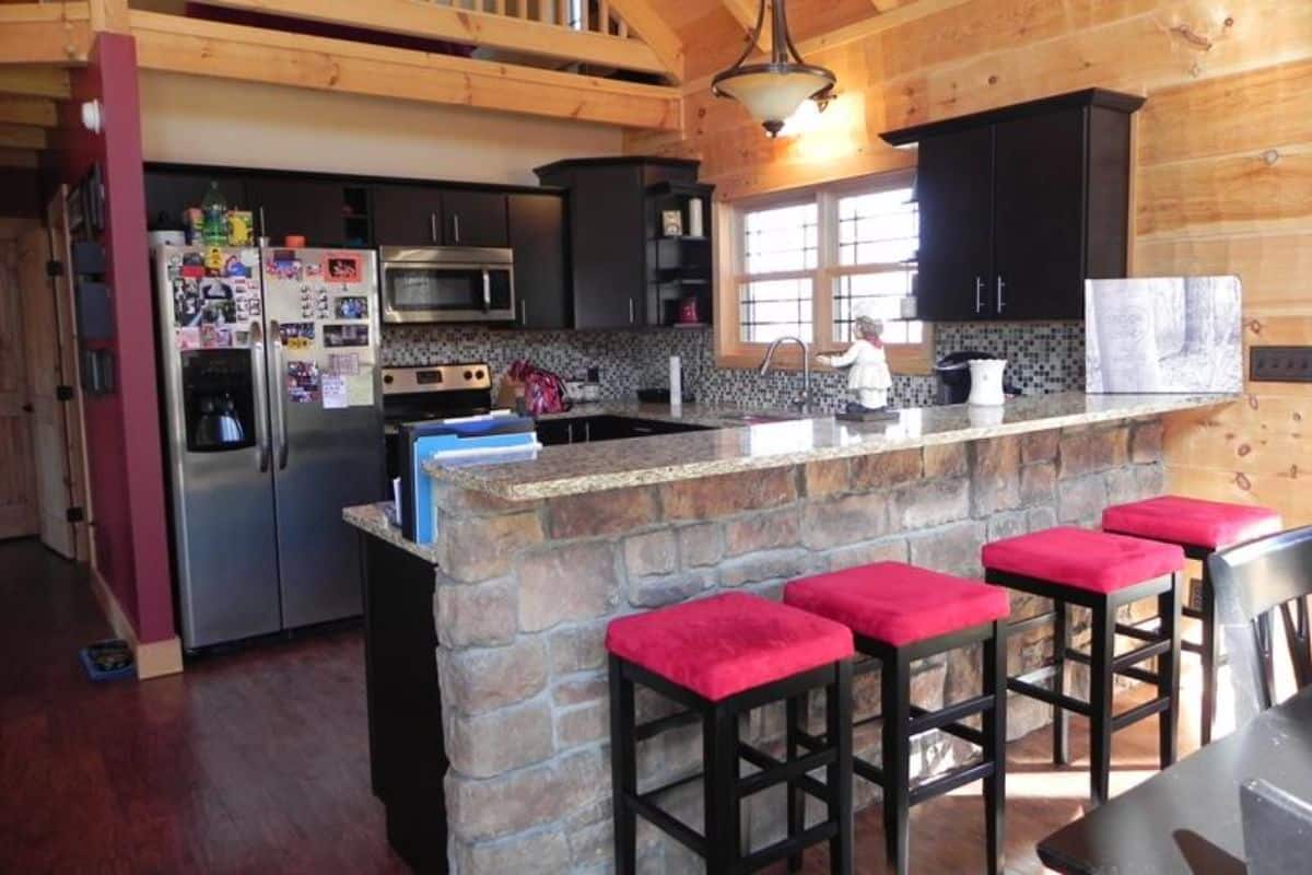 red and black stools against edge of kitchen bar