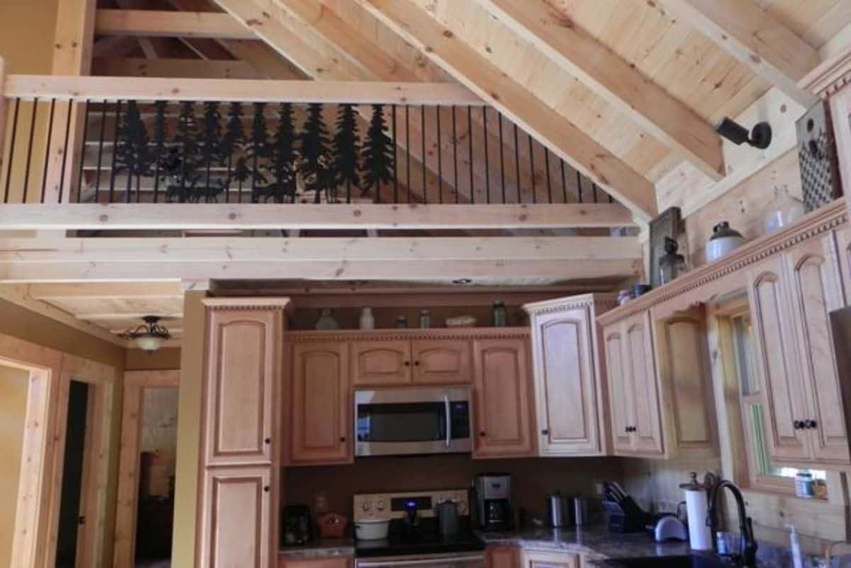 view of the iron railing on the loft above the kitchen