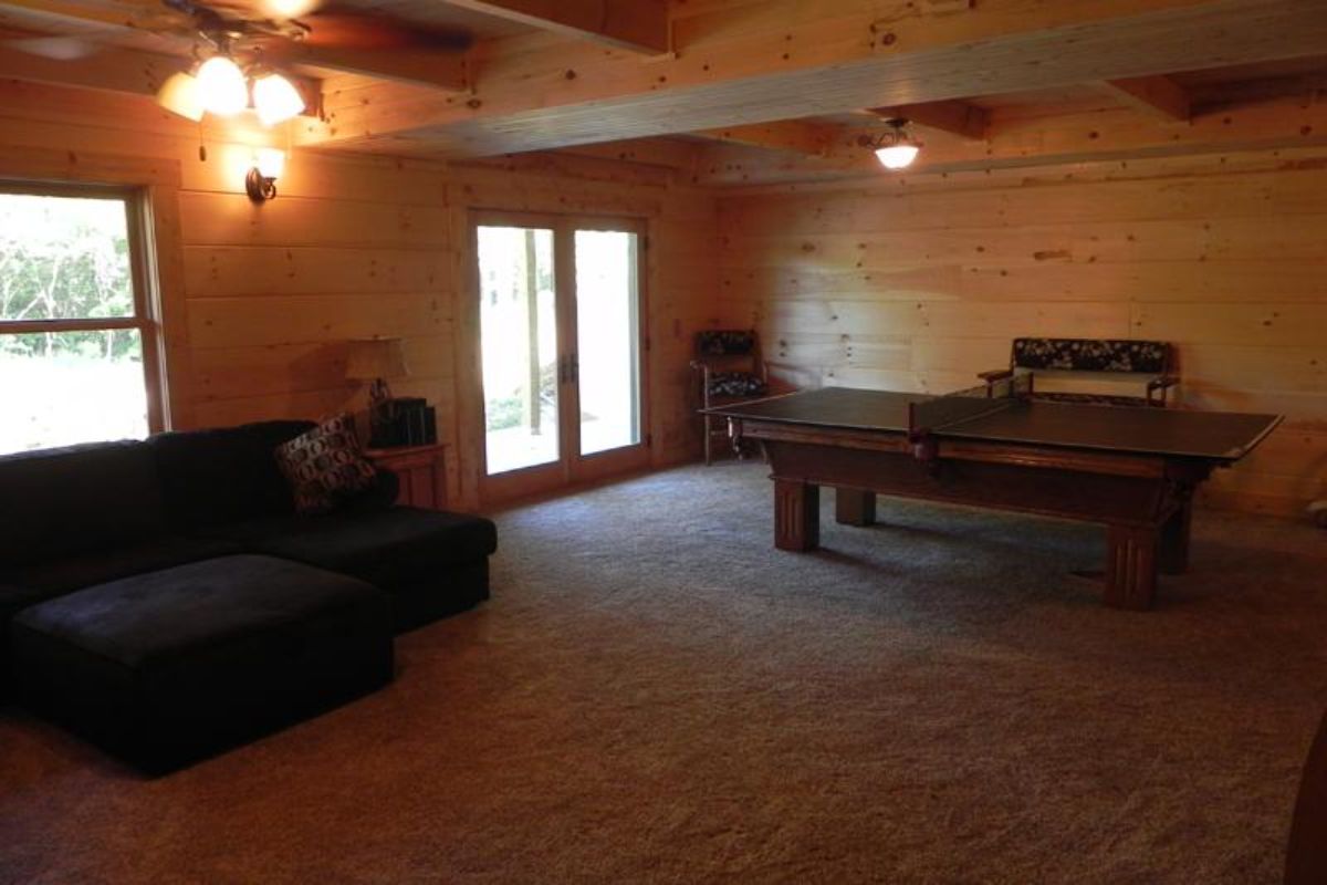 pool table and sofa in walkout basement