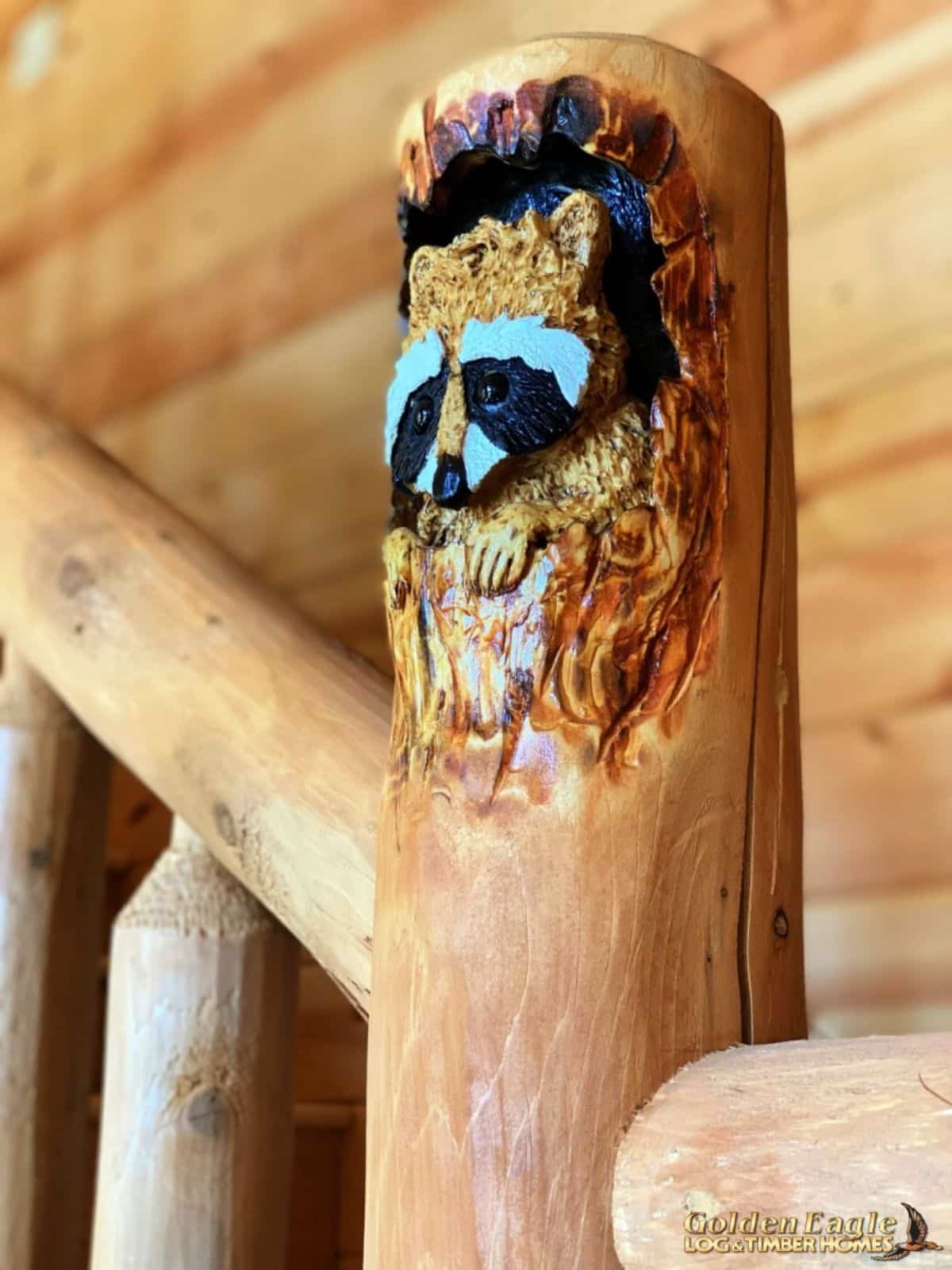 raccoon carved into wooden beam n staircase