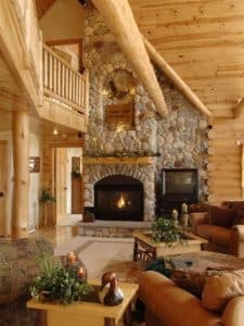 fireplace against back wall with loft railing just above