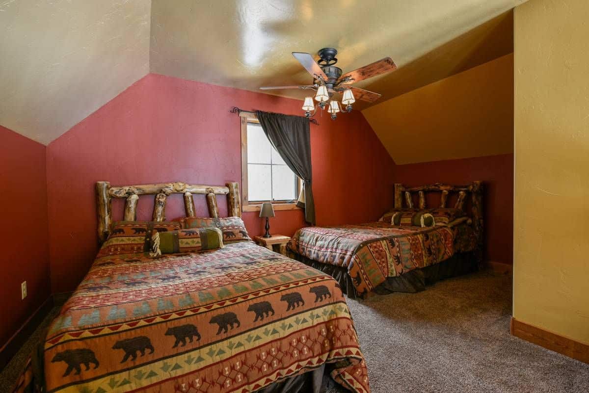 dark red walls in loft bedroom of cabin with bear print bedding