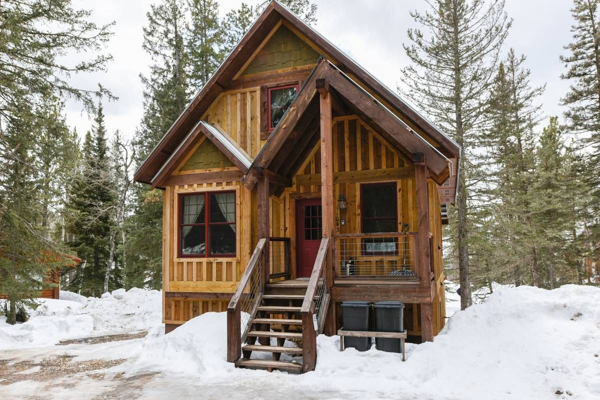 small covered porch on cabin in the snow