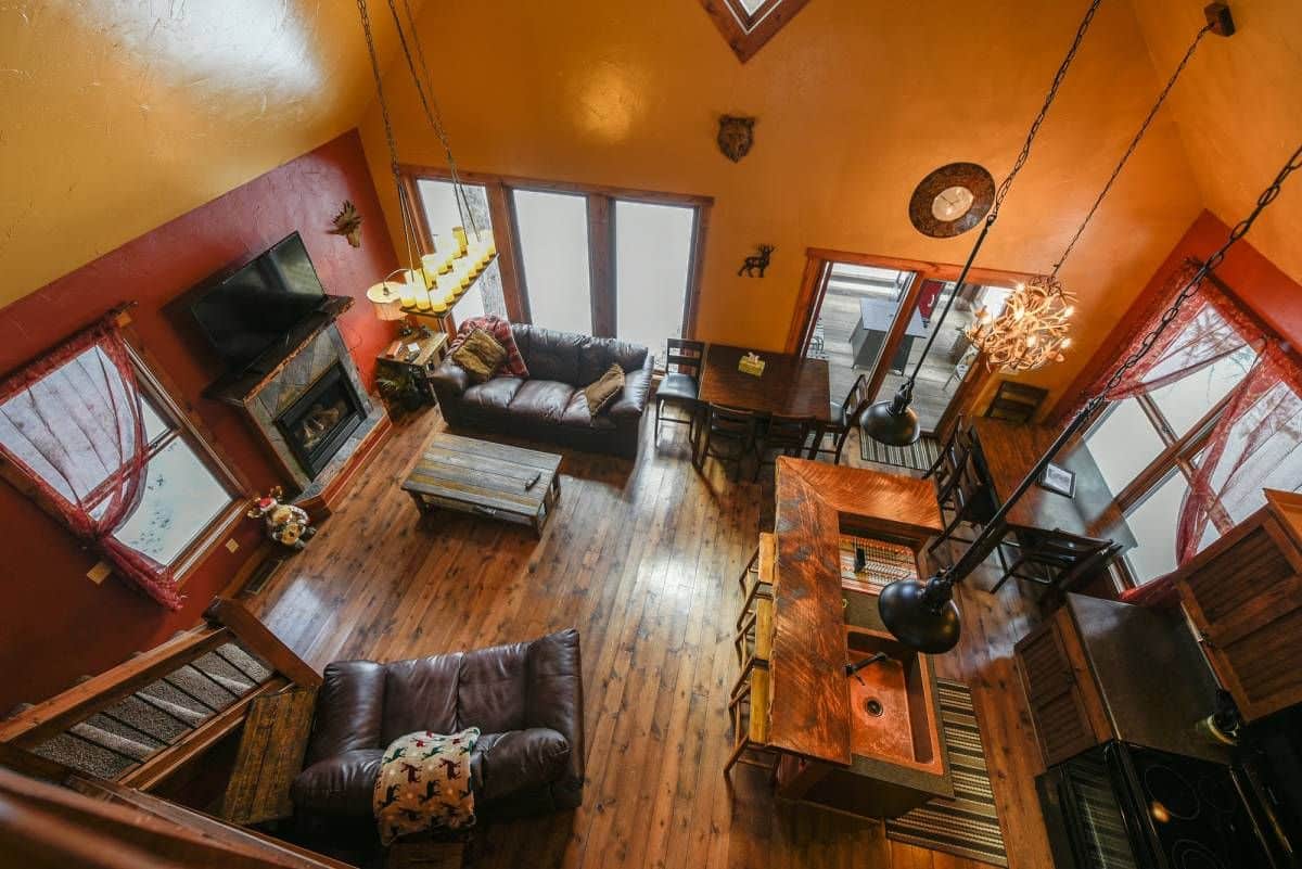 view into log cabin living room from loft