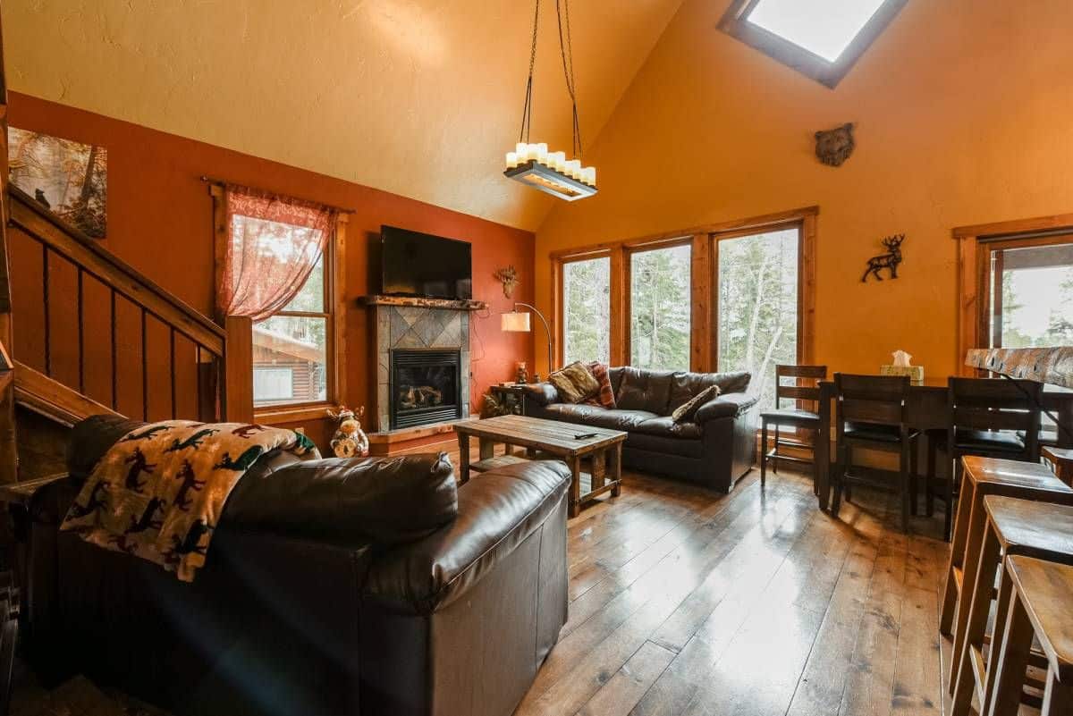 view into living room with two leather sofas by fireplace