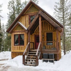 small covered porch on cabin in the snow