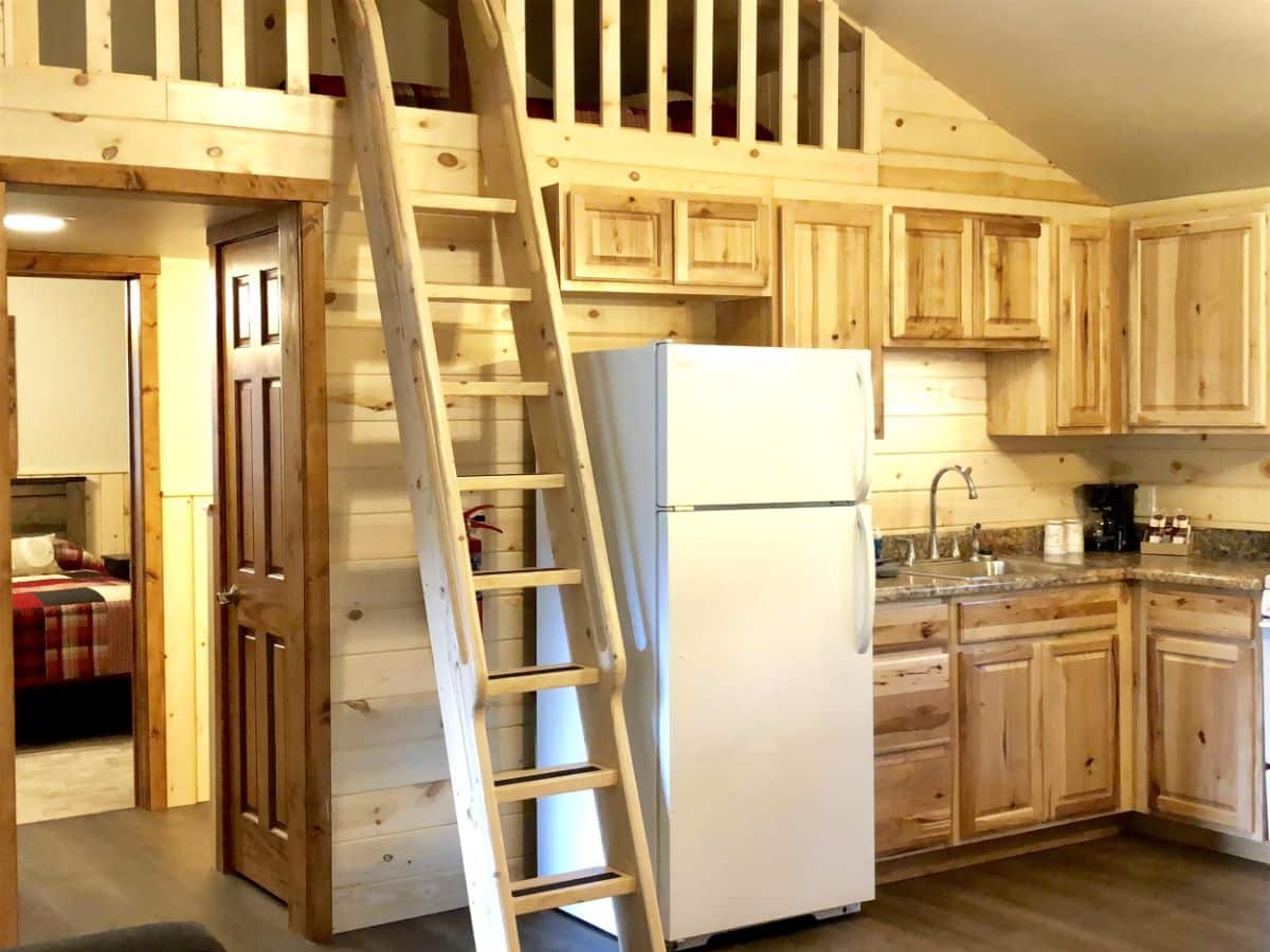 white refrigerator next to loft ladder