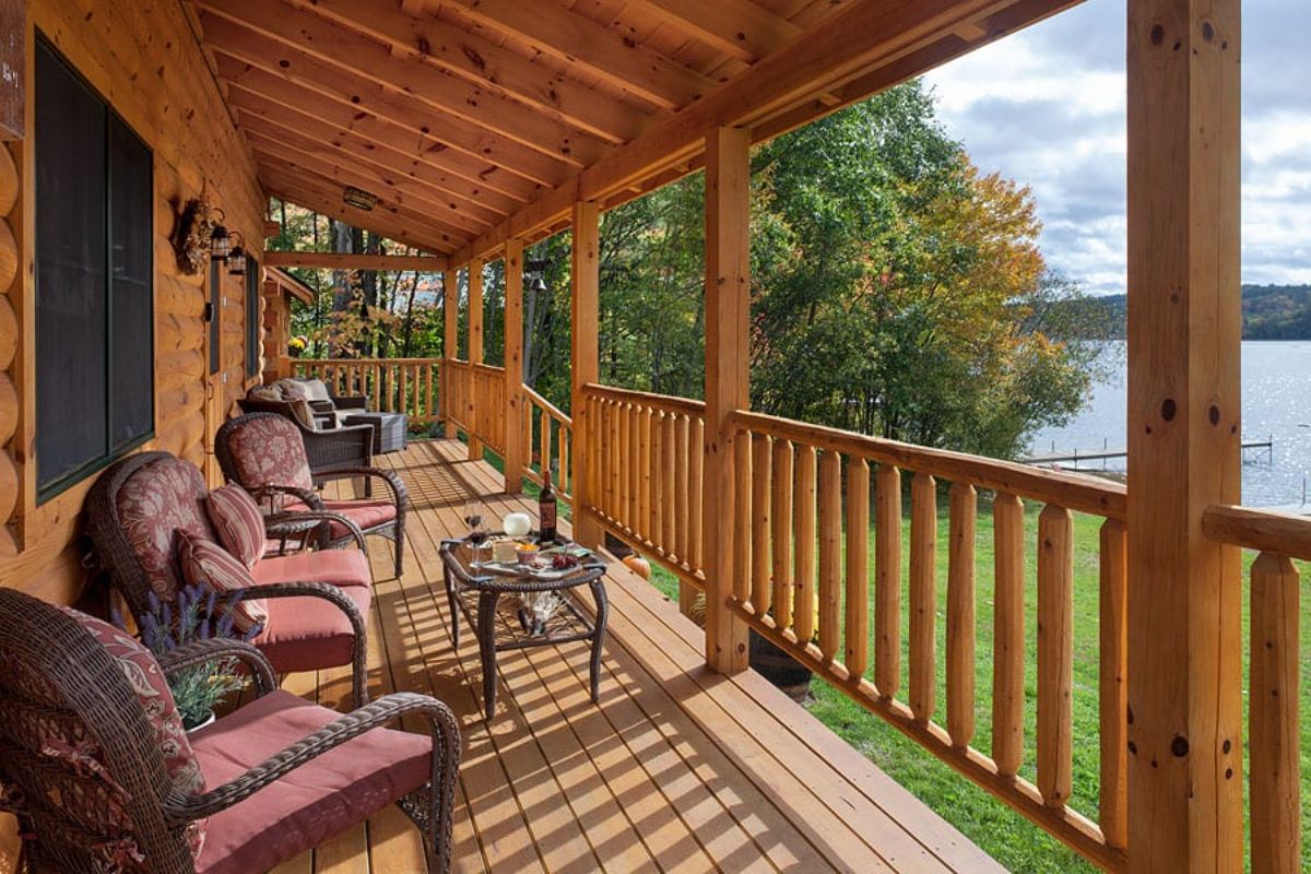 maroon chairs on porch overlooking water
