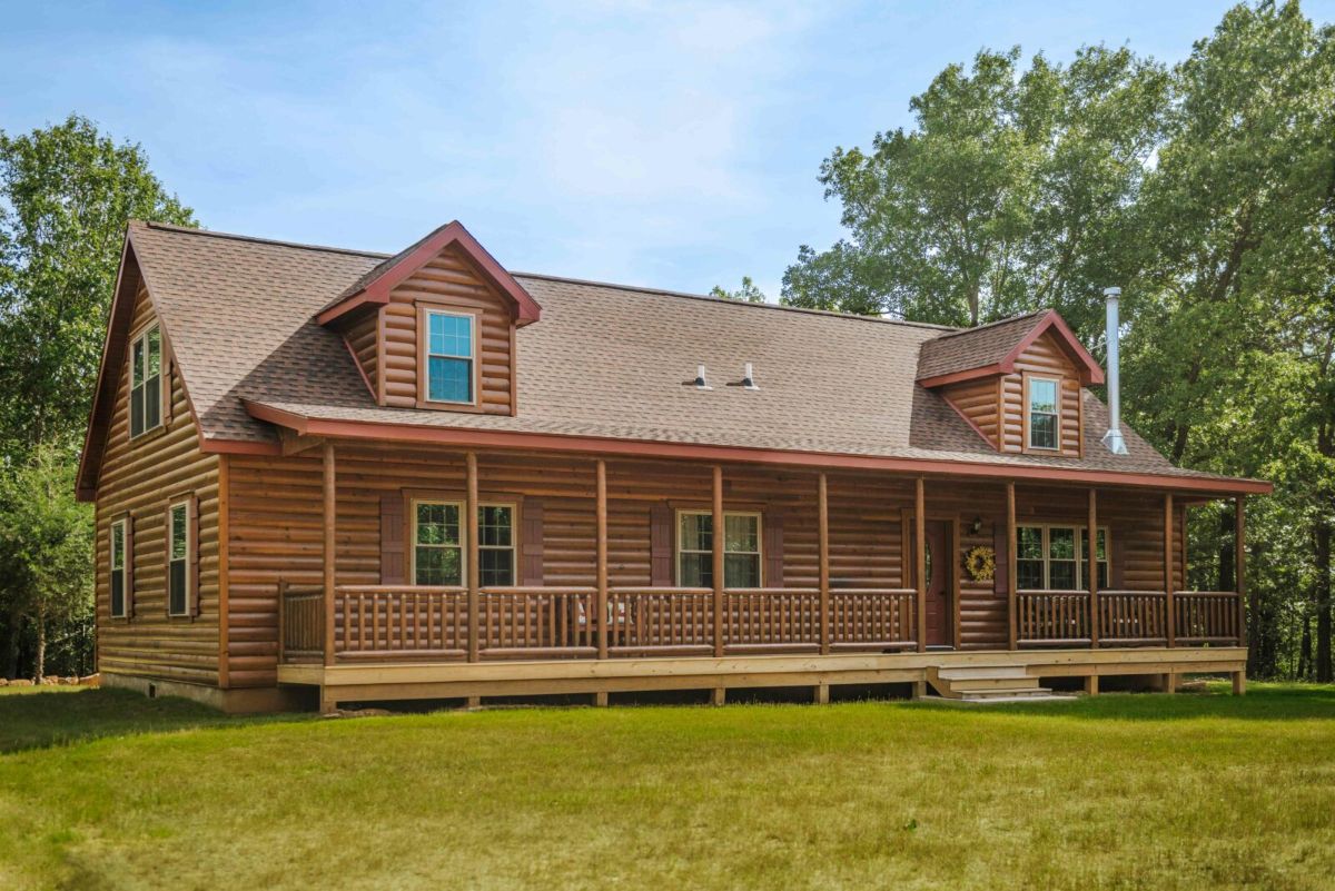 front of log cabin with covered porch