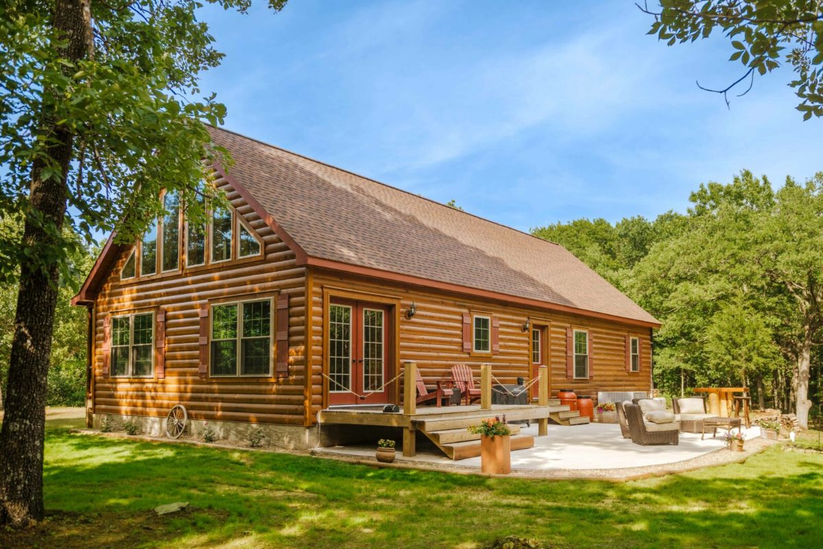 back open deck on log cabin with gravel yard