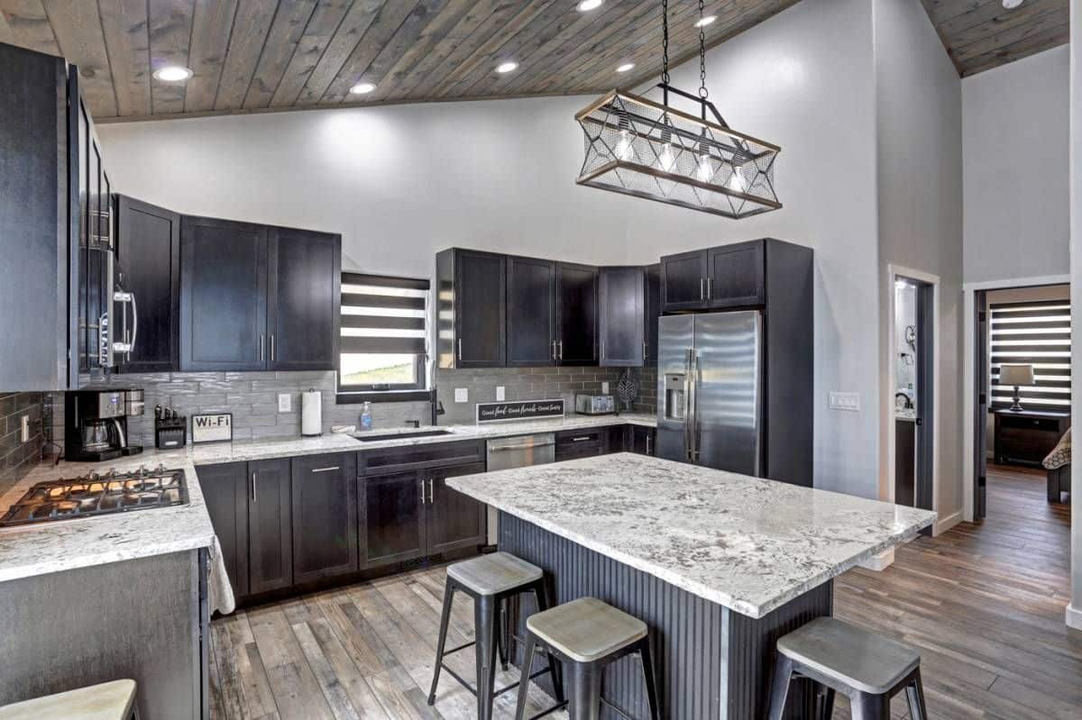 light gray marble counter tops over dark gray cabinets in kitchen