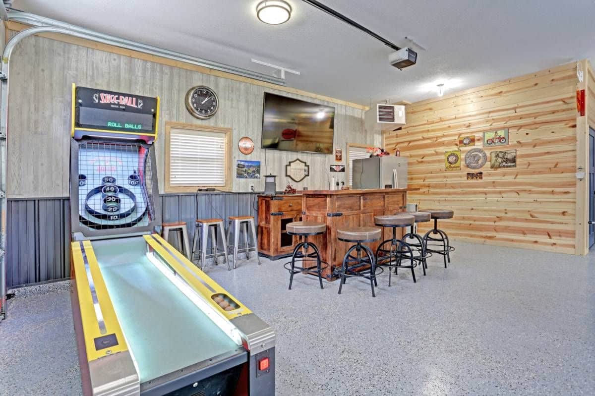 bar beneath tv against wall by skeeball table