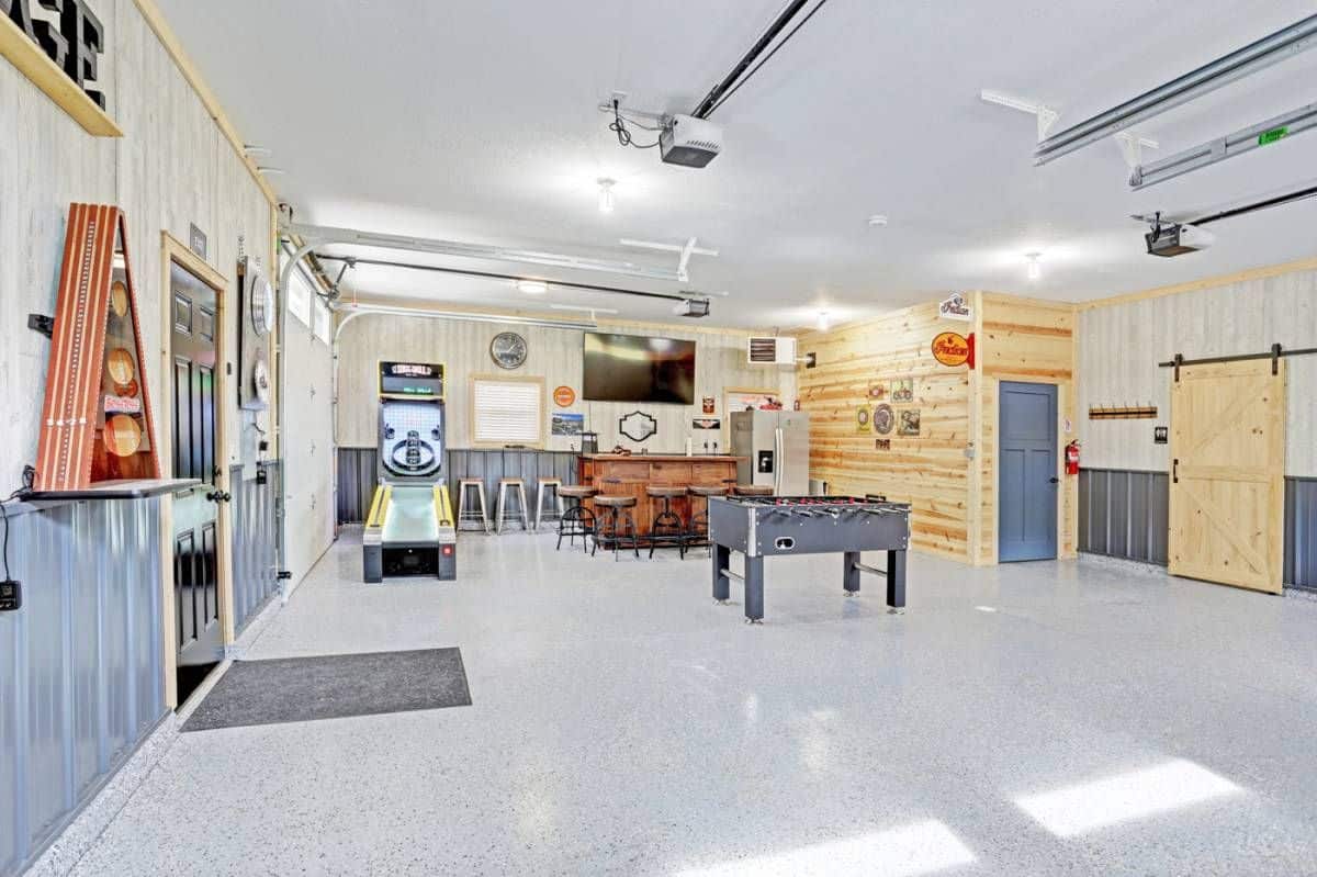 game tables and sofa against wall with white concrete floors