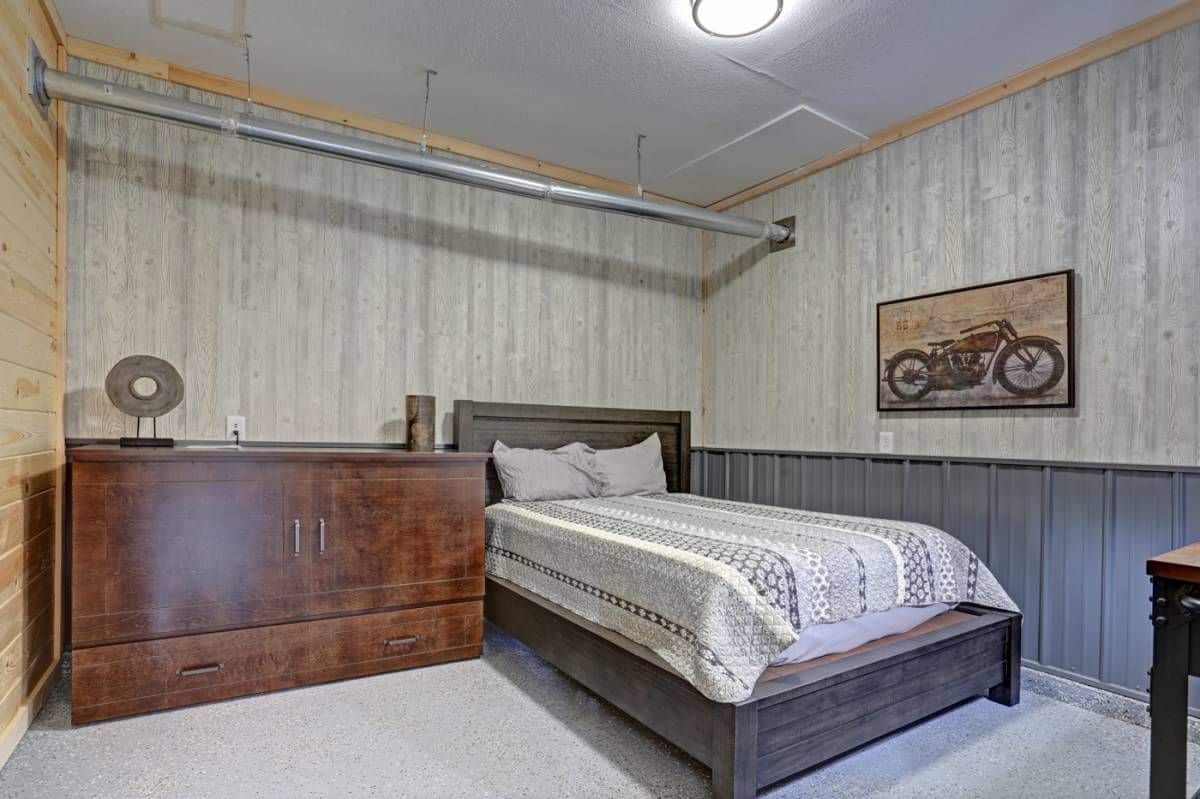 gray bed platform against light gray walls and next to wooden wardrobe