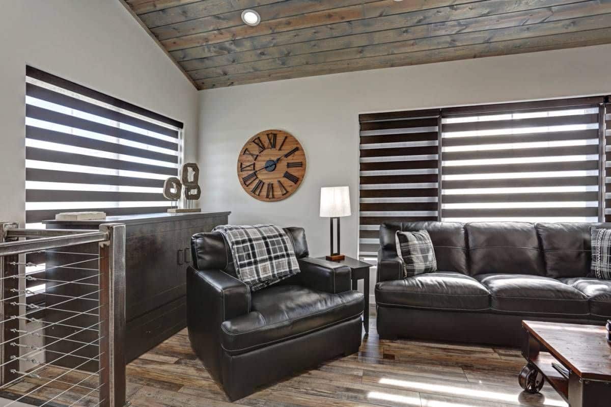 corner of living room with gray cabinets and dark gray sofa and chairs