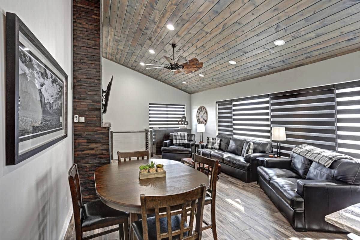 round dining table in corner by fireplace of living room beside kitchen