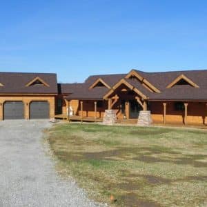 front of log cabin with three car garage