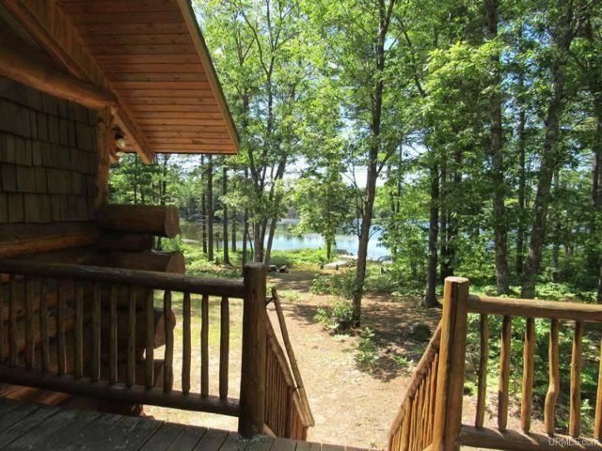 view of lake and trees from porch