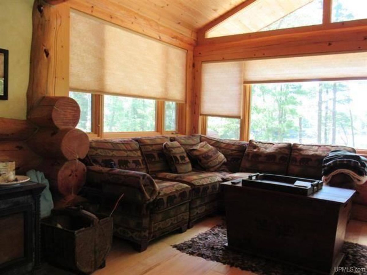 extra living space with windows on all sides and rustic sofa