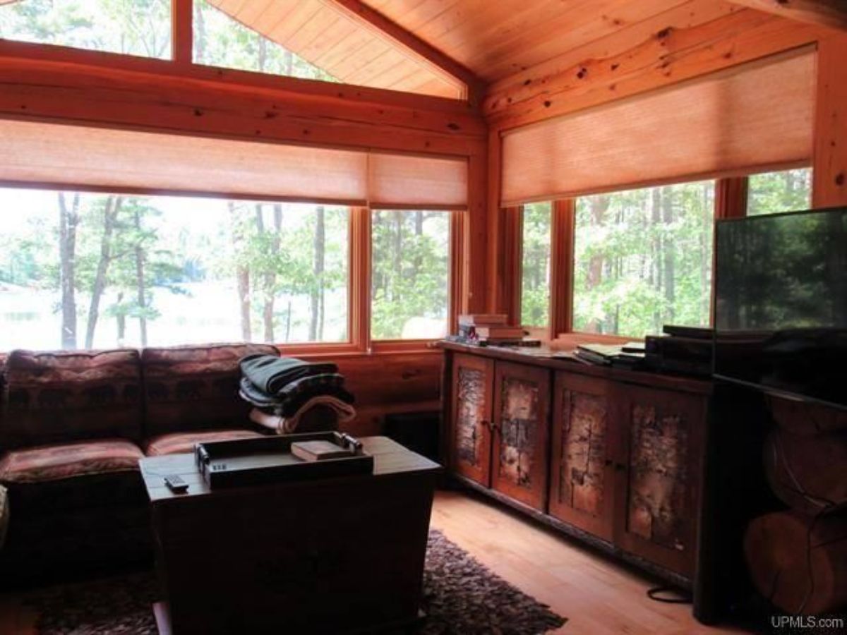 cabinets under window with sofa on left