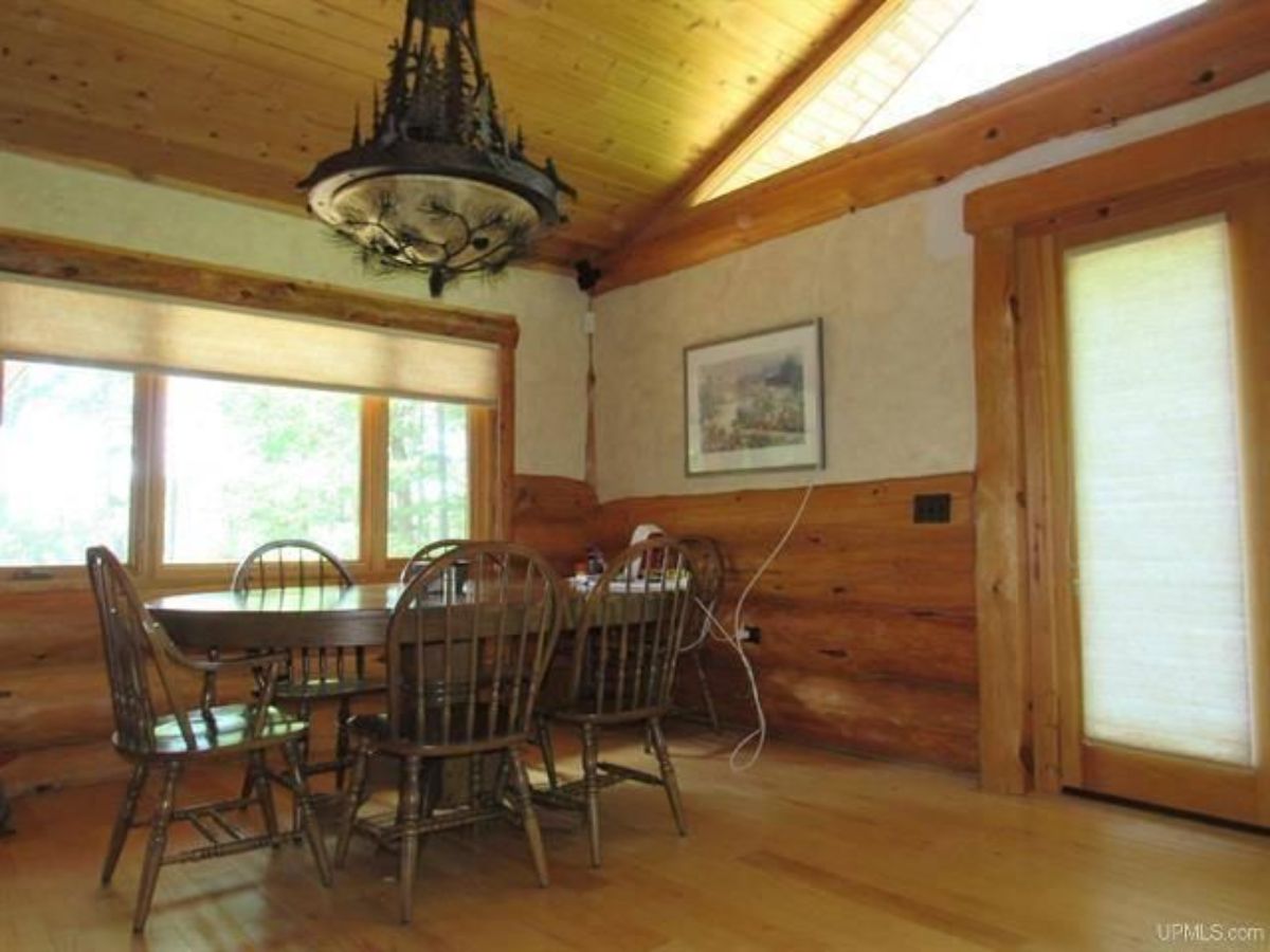 dining table underneath ornage chandelier