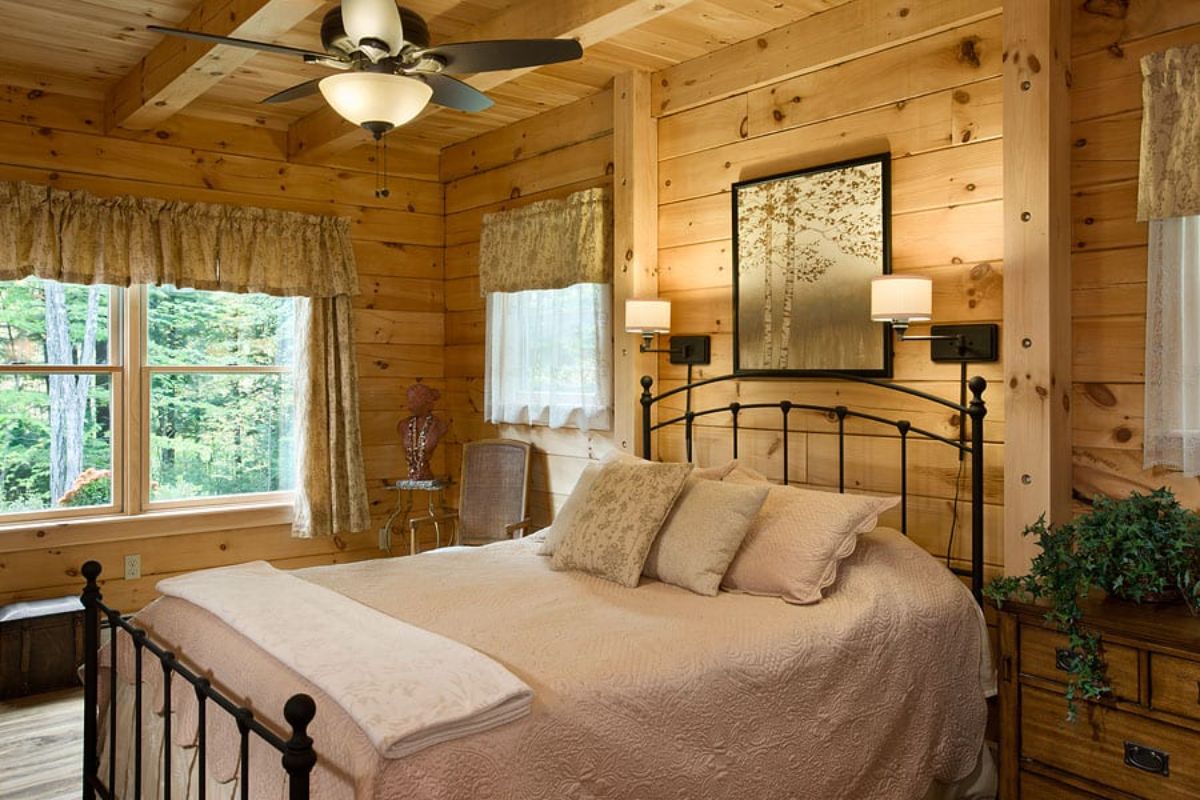 cream bedding on cabin bed with wrought iron bed frame