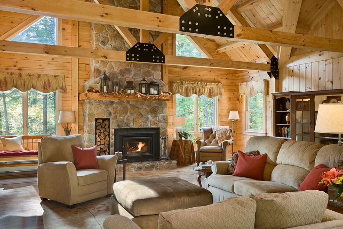 view across living room with stone fireplace against wall and cream sofa in foreground