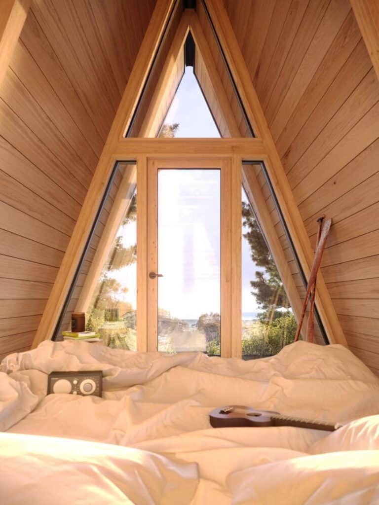 inside a-frame cabin with white bedding