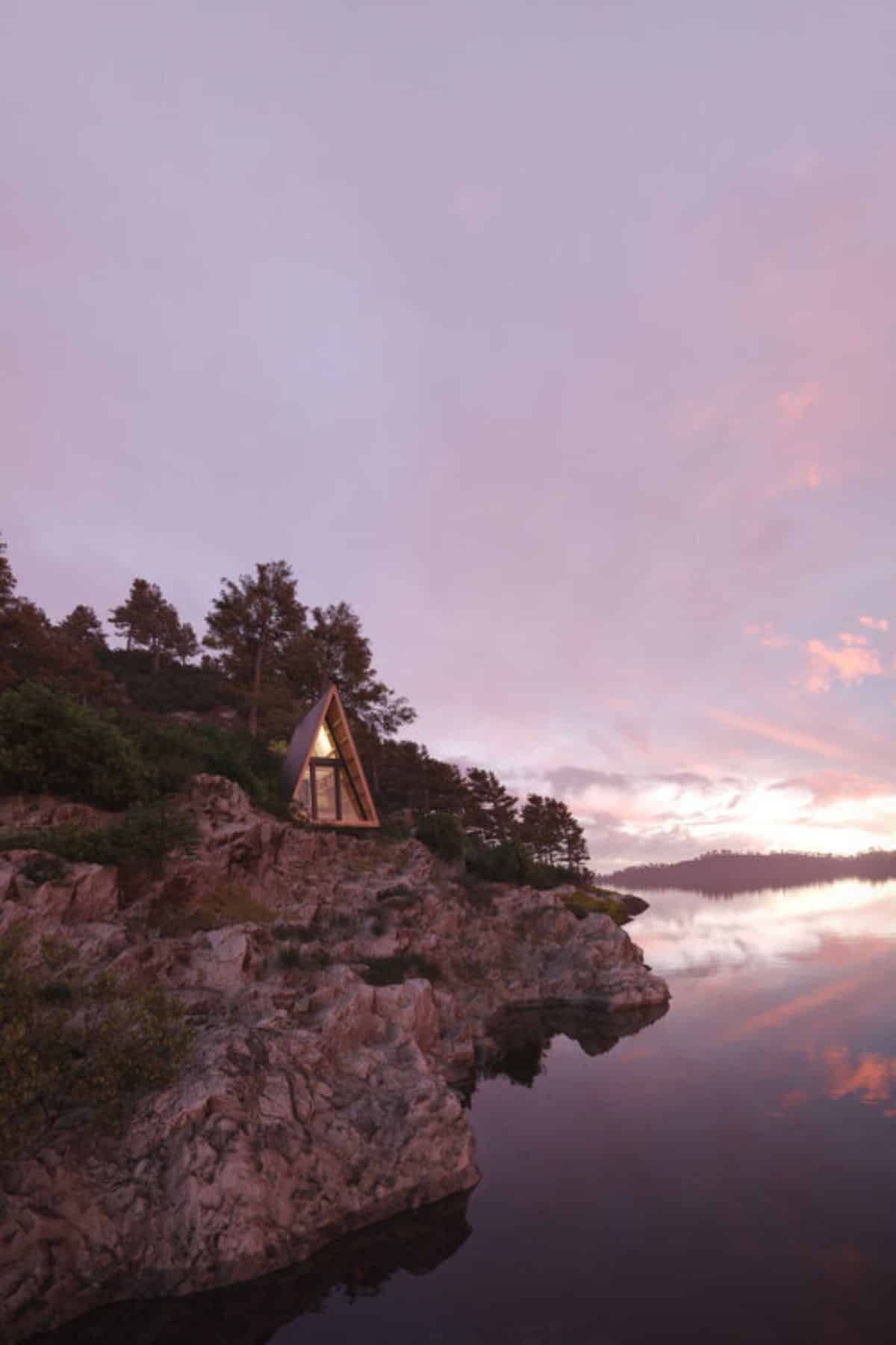 a-frame located on cliff overlooking awter