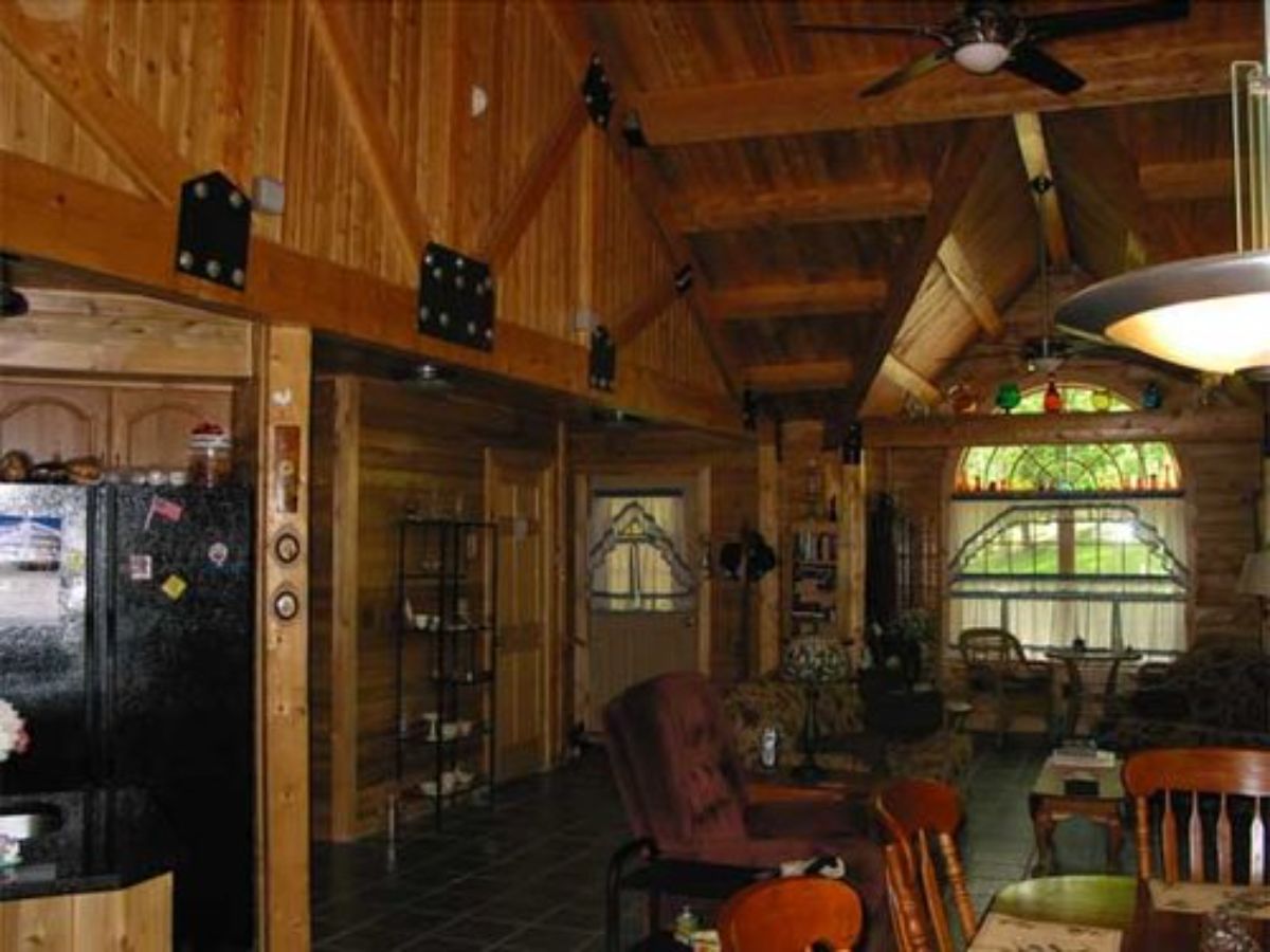 interior main floor space of cabin with wood table and multiple chairs