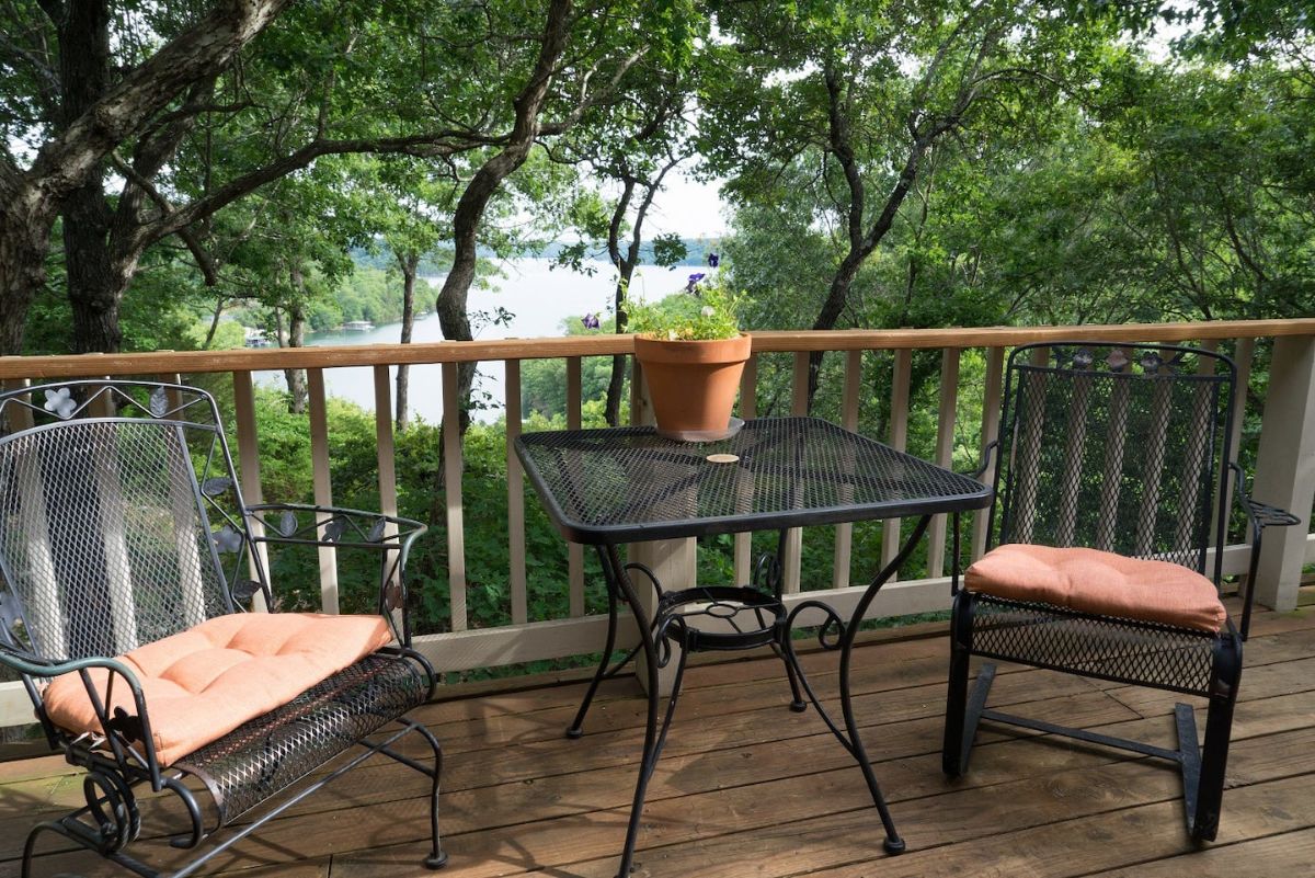 bistro set against wood railing on deck