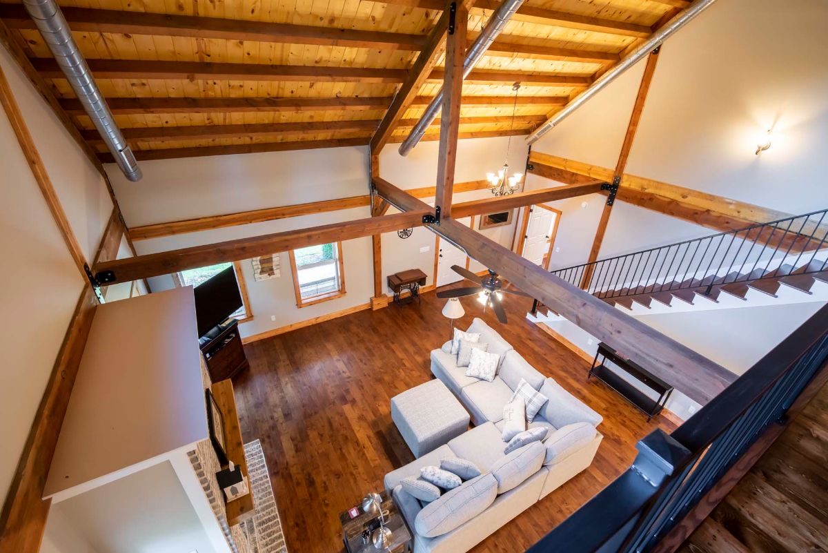 image looking down from loft to living room showing light sectional sofa