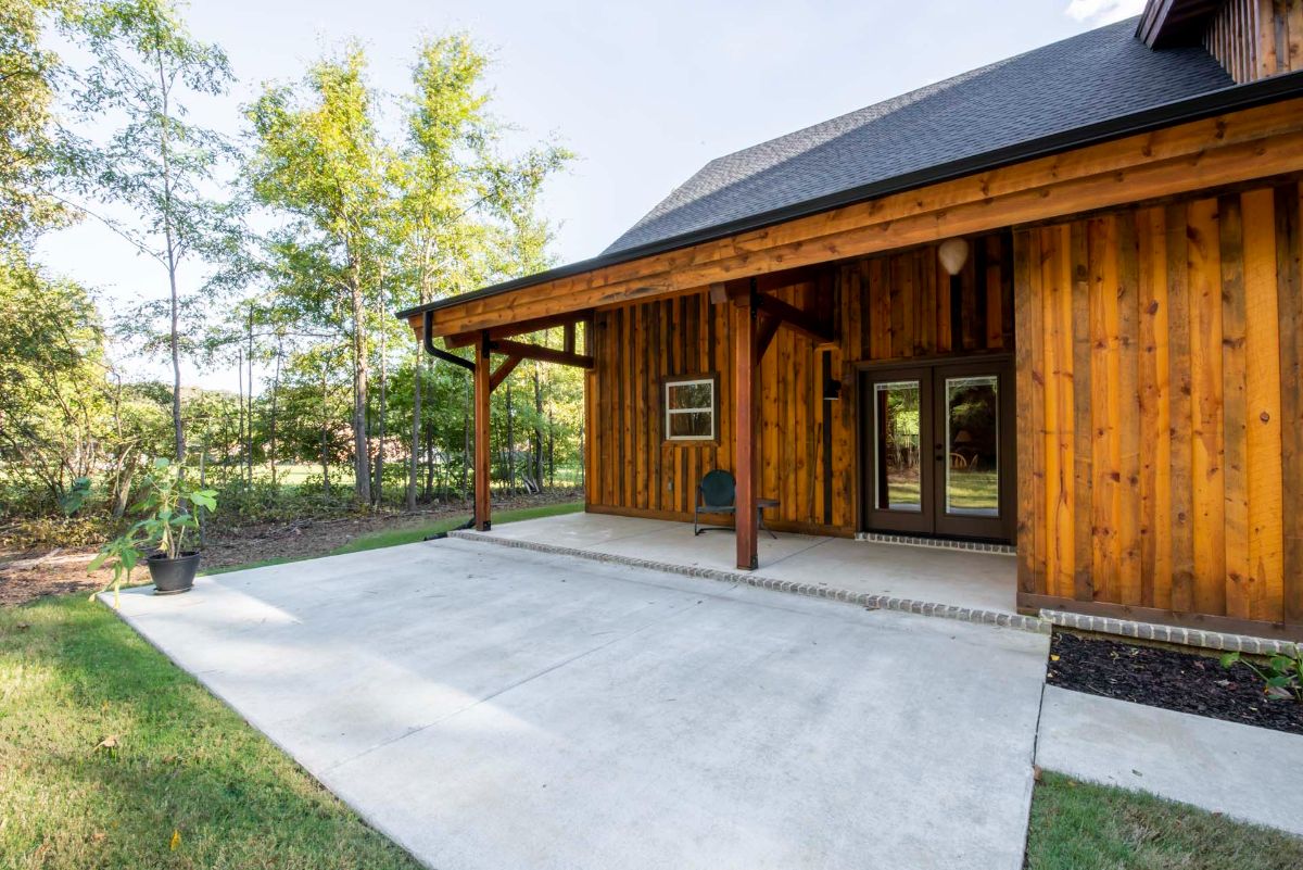 concrete patio outside back of log cabin